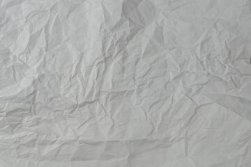 Crumpled white paper background.