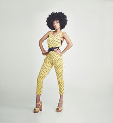 Groovy style. Studio shot of a young woman wearing a jumpsuit.