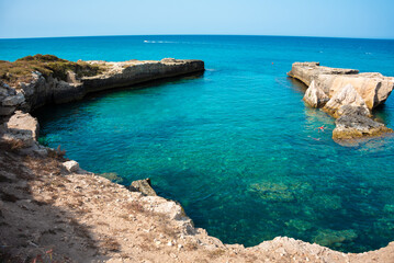 Beautiful rocky sea coast in Italy with clear water and stacks