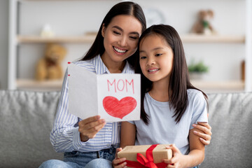 Happy asian loving daughter greeting mom with Mothers Day, young woman holding and reading handmade...