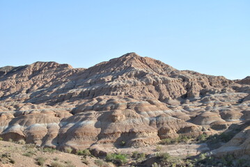 Fototapeta na wymiar Charyn Canyon in Kazakhstan. Valley of castles in Kazakhstan. An analogue of the American Grand Canyon. Aeolian landforms. Colorful stone mountains in the desert. Desert. Plain.