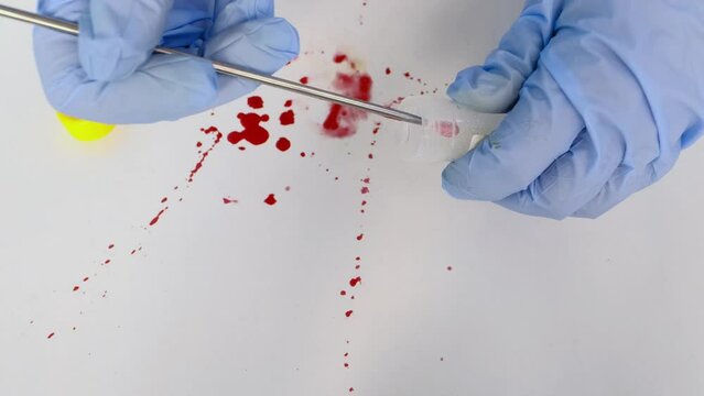 evidence idfresh splatter of red blood on white table, sharp knife stained at crime scene, forensic expert examines surfaces, collects evidence, forensic medical examiner work concept