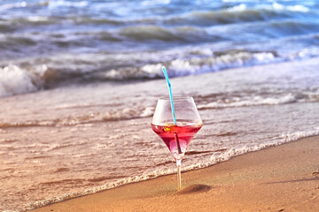 Wine glass with a cocktail by the sea.