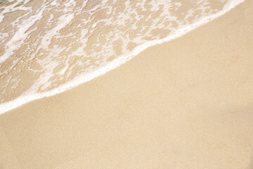 Fototapeta na wymiar beautiful texture of sandy beach, white sea foam, building sand castles, summer vacation, fun on the beach