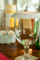 Empty Glass with a paper cover on a table for serving at a Restaurant