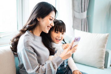 image of mother and daughter cuddling on the sofa