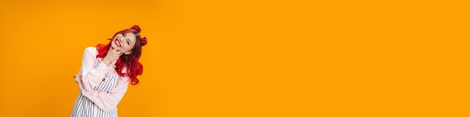 Happy girl with red hair smiling and looking at camera