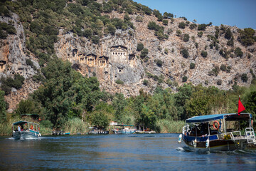 Naklejka premium Rock-cut temple tombs in Kaunos Dalyan - Turkey (Turkish name; kaya mezarlari) Ancient city of Kaunos, Dalyan valley, Turkey. Kaunos (Latin: Caunus) was a city of ancient Caria and in Anatolia