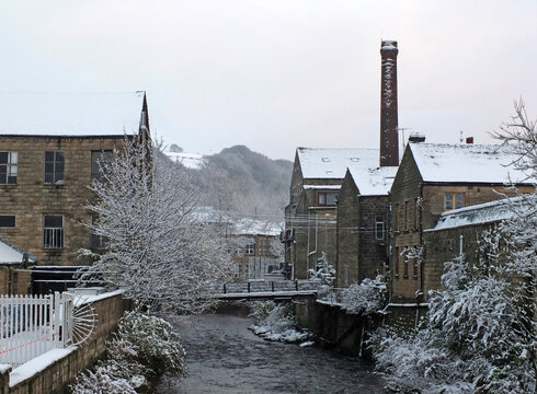 falling snow over the river calder in the west yorkshire town of hebden bridge