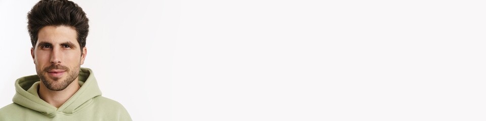 Obraz premium Pleased handsome man in sportswear posing and looking at camera