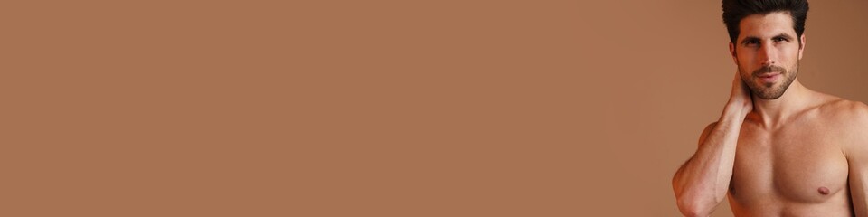 Fototapeta premium Shirtless masculine man posing and looking at camera