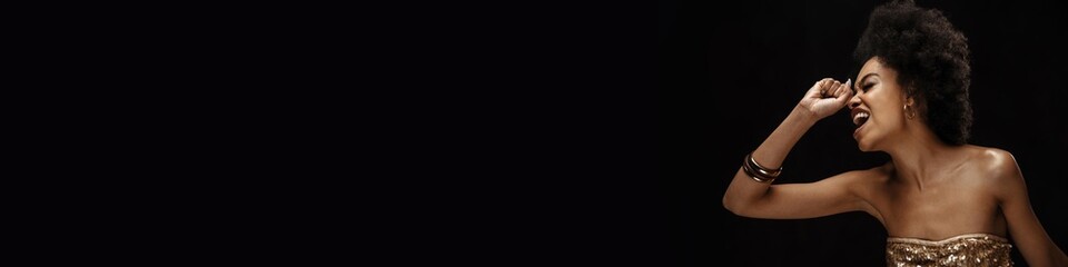 Happy young african woman in dress standing