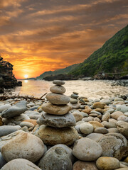Pile of stones stacked on a beach in the storm river mouth in the Tsitsikamma national park Garden...