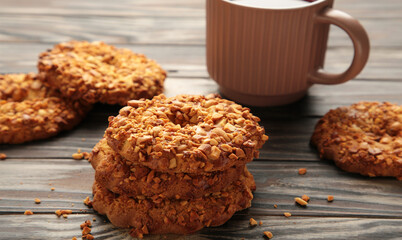 Peanut cookies with tea on brown background. Bakery products.