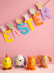 Inscription Easter on rope with clothespins and eggs. The concept of postcards for the Easter holiday.