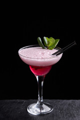 Alcoholic drinks at the bar. Bartender's hands in the process of making drinks.