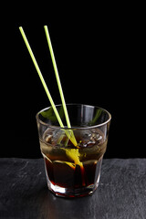 Alcoholic drinks at the bar. Bartender's hands in the process of making drinks.