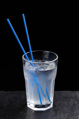 Alcoholic drinks at the bar. Bartender's hands in the process of making drinks.