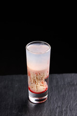 Alcoholic drinks at the bar. Bartender's hands in the process of making drinks.