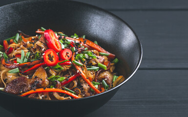 Asian cuisine, teriyaki meat with vegetables, in a cast-iron frying pan, close-up, no people,
