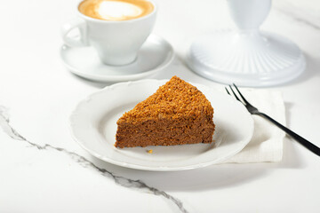 A piece of honey cake on a white plate
