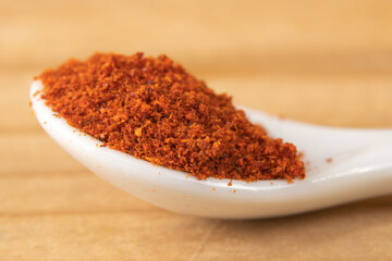 Macro of cayenne pepper in a small white spoon