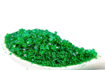 Close-up of green confectionary sugar in white background