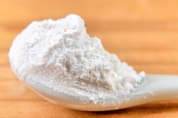 Cream of tartar powder in a white spoon