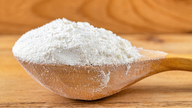 Macro of gluten free flour in a wood background