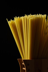 Dry spaghetti on a black background. Traditional pasta close-up. Italian food
