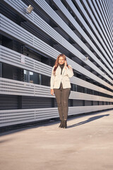 businesswoman talking on smart phone while walking