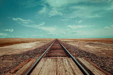 Straight rail track in the wide lands of Montana