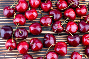 Sweet and ripe red cherry on wooden background. Summer fruit close up image