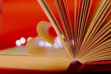 Love concept with open book. Hearts from book pages. Open book background. St Valentines Day greeting card
