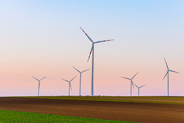 windmills turbines on sunset background