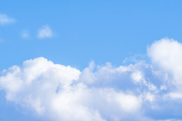 Naklejka na ściany i meble White, fluffy cloud in the blue sky.