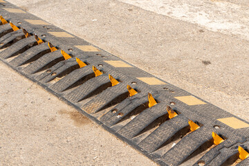 One way traffic speed bump with spikes is on the road