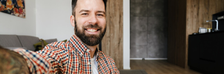 Portrait of a smiling man sitting on the floor