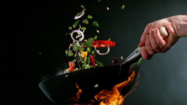 Super slow motion of flying vegetable from wok pan. Filmed on high speed cinema camera, 1000 fps. Speed ramp effect.