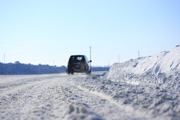 Road cleared of snow on a sunny winter day