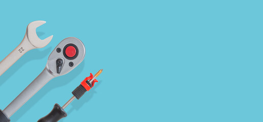 Banner with many workshop tools with shadows at solid turquoise background with copy space. Concept of hardware, gears, and workshop work.