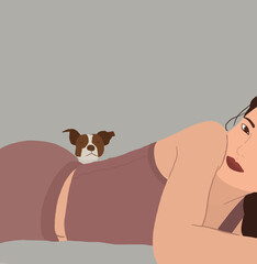 Young Korean girl posing to camera lying down while behind her is her precious doggy looking at the camera. Animal Lover Concept.