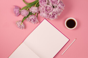 Coffee mug , an empty notebook, a pencil and pink tulips flowers on a pink background, flat style. Female desktop © Bo.graphic