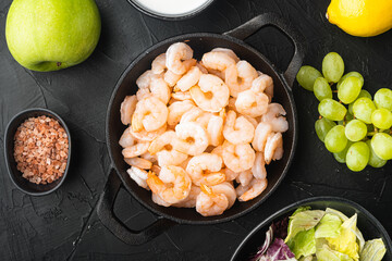 Waldorf prawn salad ingredients , with sauce apple and grape, on black stone background, top view flat lay