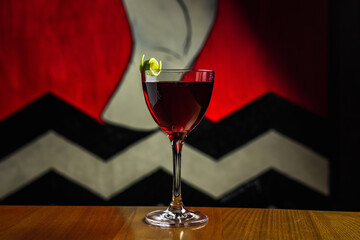 Classic Manhattan cocktail in a nick and nora glass on a wooden table