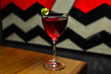 Classic Manhattan cocktail in a nick and nora glass on a wooden table