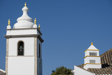 traditional chimney and  a church in the old town of Estoi, Algarve, Portugal	