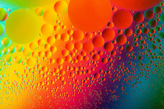 Macro photography of the oil drops on the water surface.Cosmic circles looks like molecule structure.Backdrop with copy space,good as template.