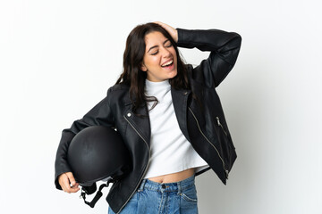 Woman holding a motorcycle helmet isolated on white background smiling a lot