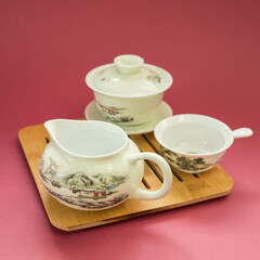 Gaivan and chahay with green tea  
 and tea brew on a pink background. Tea ceremony.  Traditional chinese tea utensils. 